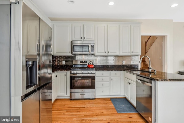 kitchen featuring white cabinets, sink, and appliances with stainless steel finishes