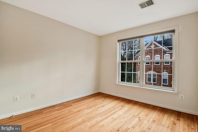 spare room with light wood-type flooring