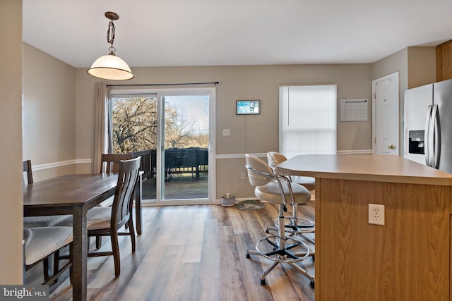 dining space with light hardwood / wood-style flooring