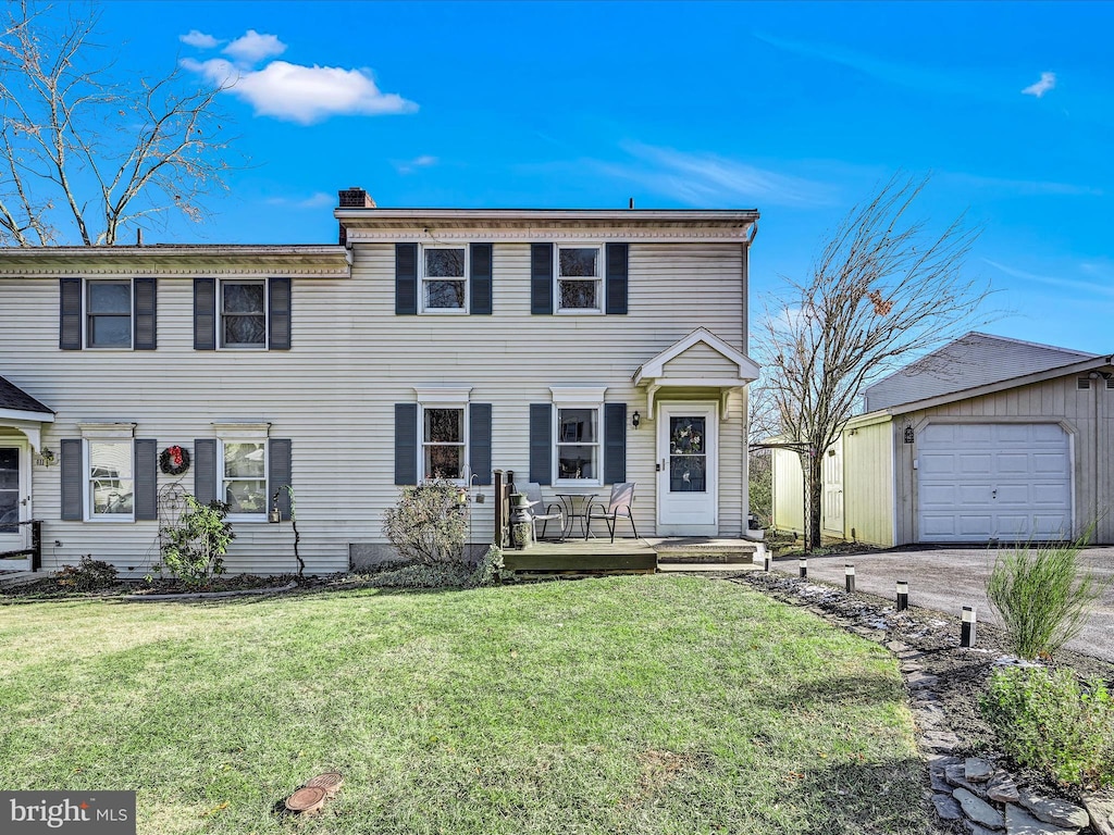 view of front of home with a garage and a front lawn