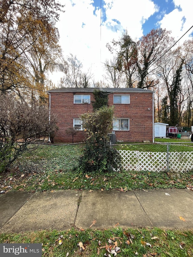 exterior space featuring a lawn and cooling unit