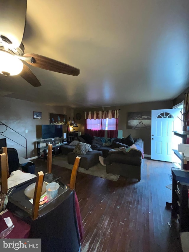 living room with ceiling fan and dark hardwood / wood-style flooring