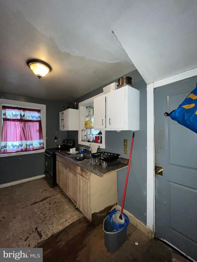 kitchen featuring white cabinets, sink, and black electric range oven