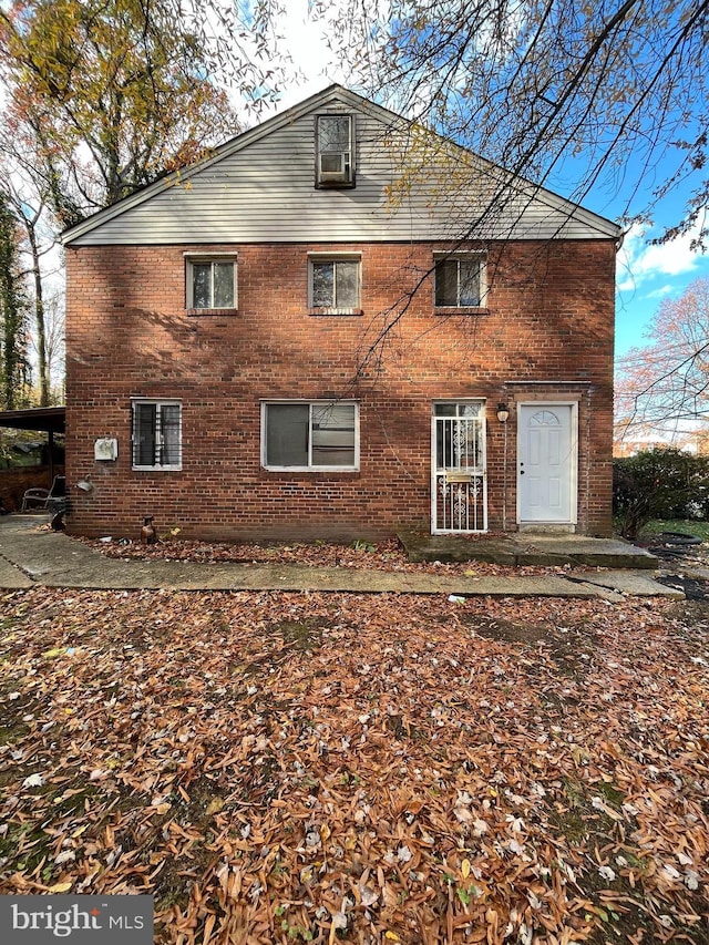 rear view of house with a carport