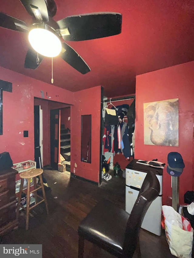 interior space featuring ceiling fan and dark hardwood / wood-style floors