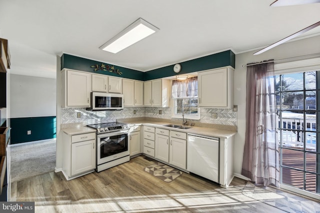 kitchen with white cabinets, dishwasher, a healthy amount of sunlight, sink, and stainless steel electric range oven