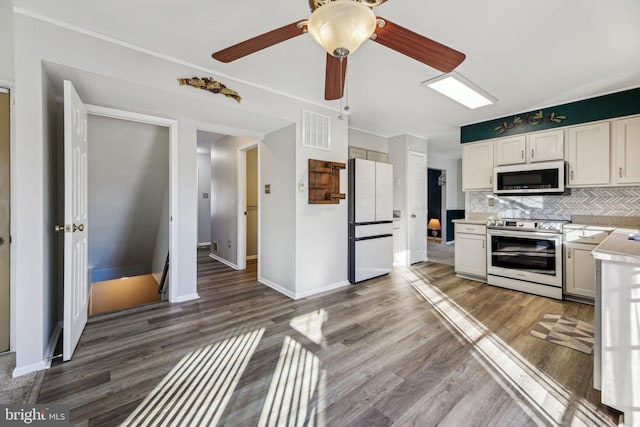 kitchen with tasteful backsplash, ceiling fan, dark hardwood / wood-style floors, white appliances, and white cabinetry