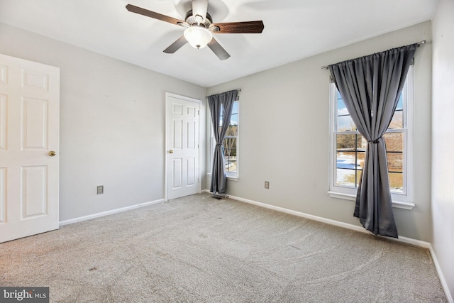 empty room featuring ceiling fan and carpet flooring