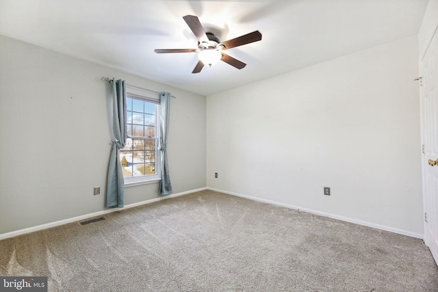 spare room with carpet floors and ceiling fan