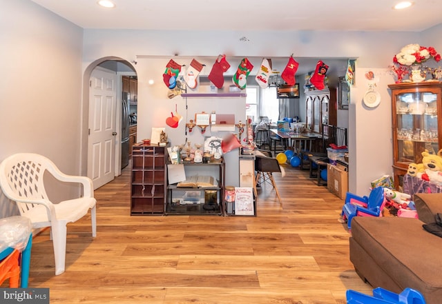 interior space featuring stainless steel fridge and light hardwood / wood-style flooring