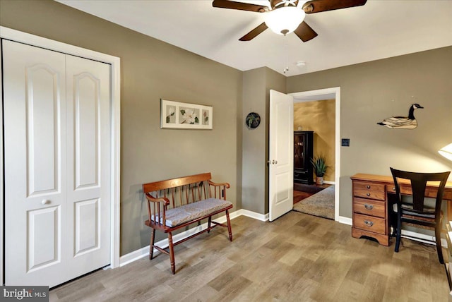 home office featuring ceiling fan and light hardwood / wood-style floors