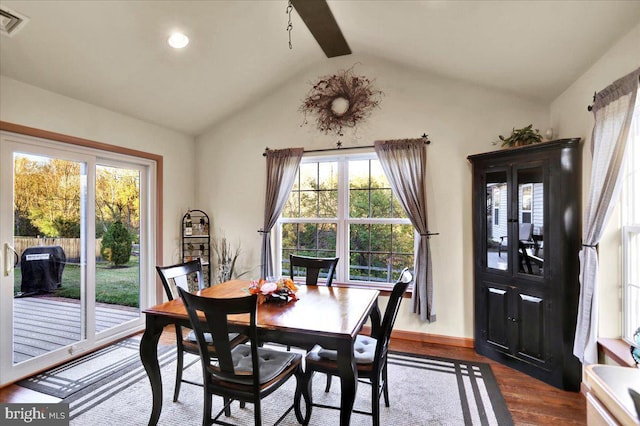 dining space with wood-type flooring and lofted ceiling