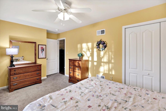 carpeted bedroom with ceiling fan and a closet