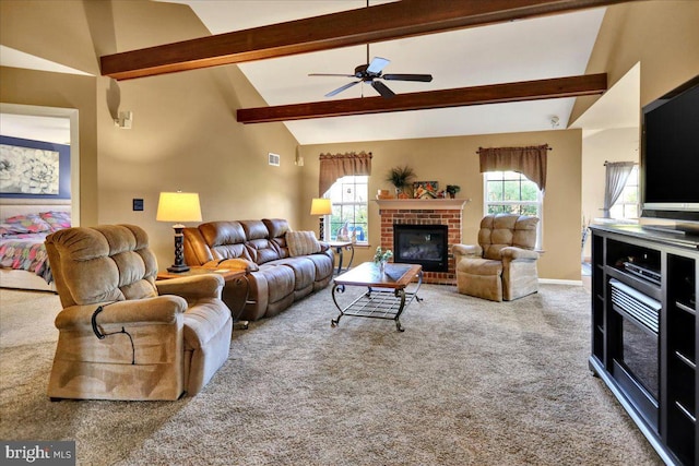 carpeted living room featuring a fireplace, vaulted ceiling with beams, and ceiling fan