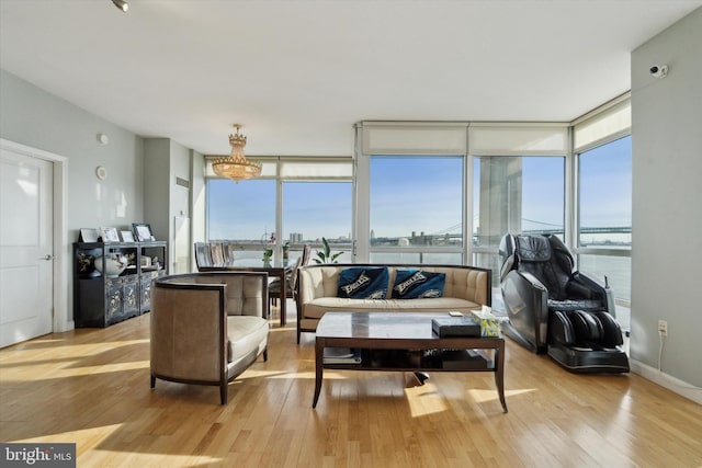 living room with expansive windows, light hardwood / wood-style flooring, and a wealth of natural light