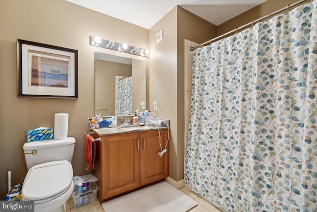 bathroom featuring tile patterned floors, vanity, and toilet