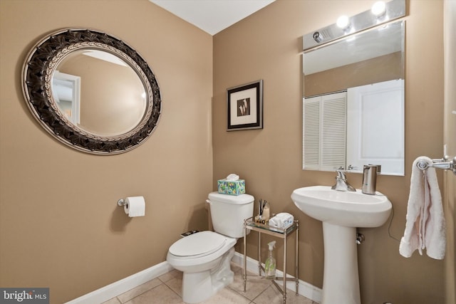 bathroom with tile patterned floors, toilet, and sink