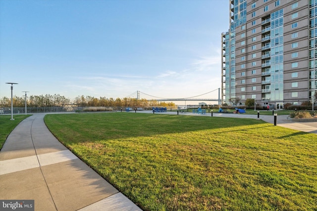 view of property's community with a lawn and a water view