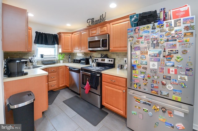 kitchen featuring backsplash, sink, light tile patterned floors, and stainless steel appliances