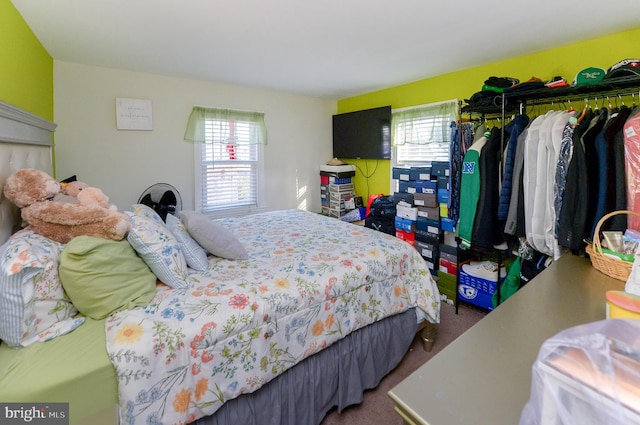 bedroom featuring dark carpet