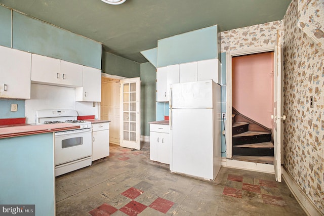 kitchen featuring white appliances and white cabinets