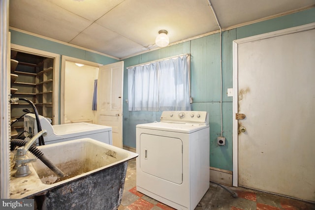 laundry room featuring sink, washing machine and clothes dryer, and ornamental molding