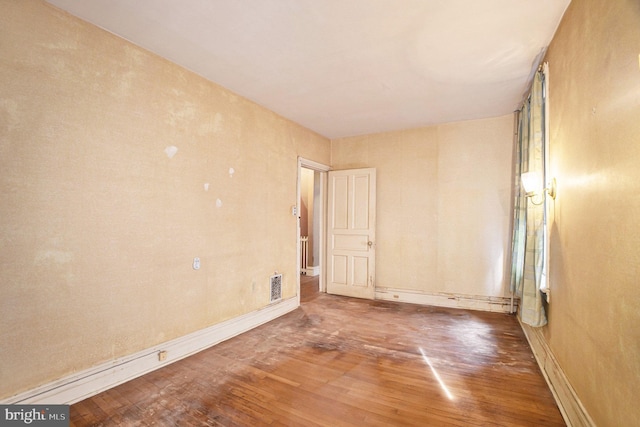 empty room featuring hardwood / wood-style flooring