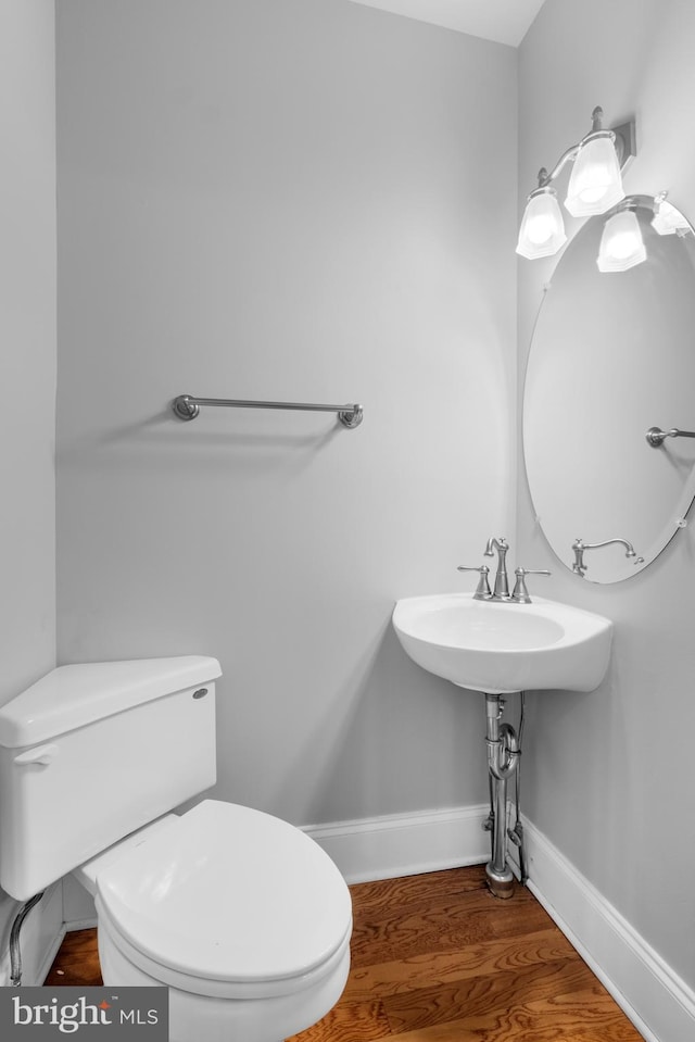 bathroom featuring hardwood / wood-style floors and toilet