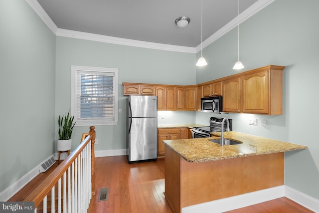 kitchen with stainless steel appliances, light stone counters, ornamental molding, and sink