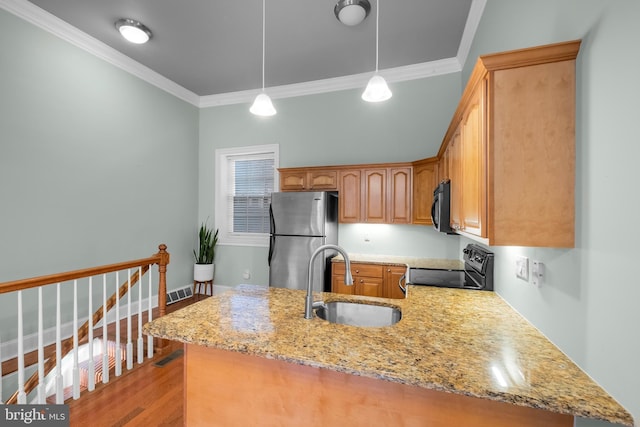 kitchen featuring pendant lighting, black appliances, crown molding, sink, and light stone countertops