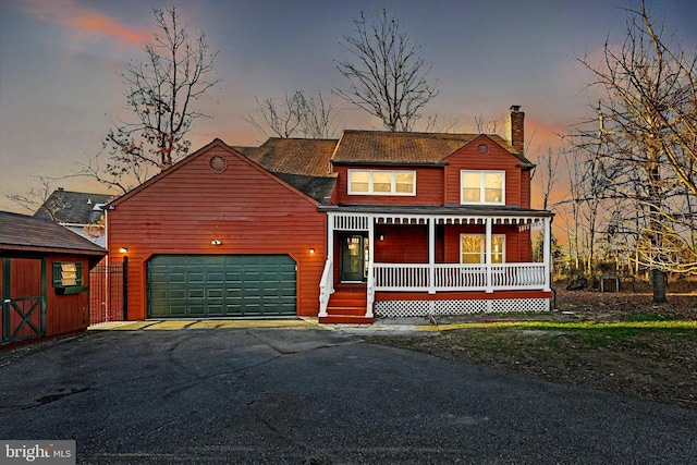 view of front of house with covered porch and a garage