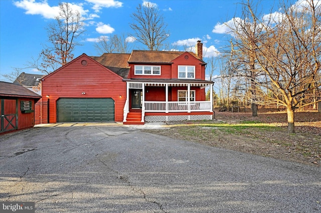 view of front of home with covered porch and a garage