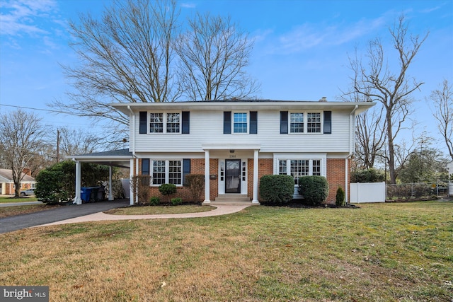 view of front of house featuring a carport and a front yard