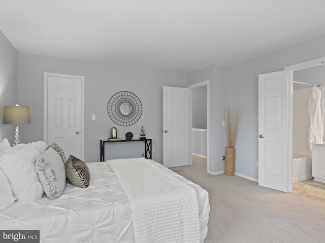 carpeted bedroom featuring connected bathroom