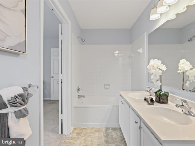 bathroom with tiled shower / bath and vanity