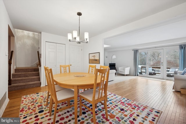 dining area featuring an inviting chandelier and light hardwood / wood-style floors