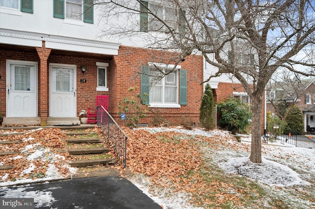 view of snow covered property entrance