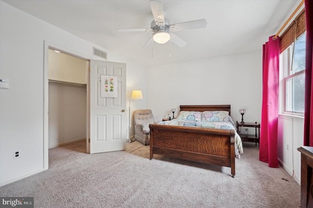 bedroom featuring ceiling fan, light colored carpet, and multiple windows