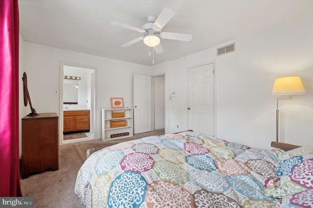 bedroom with ensuite bathroom, ceiling fan, and light carpet