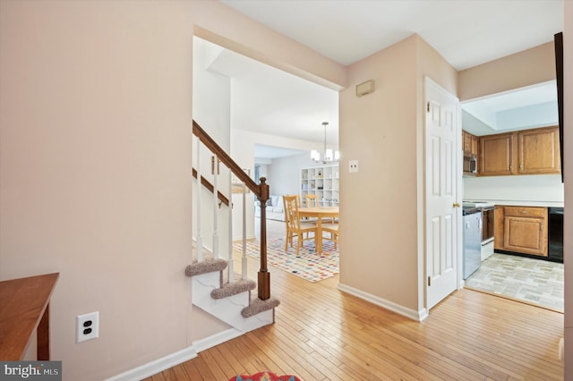 hallway featuring a chandelier and light hardwood / wood-style floors