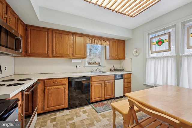 kitchen featuring dishwasher, white electric range oven, and sink