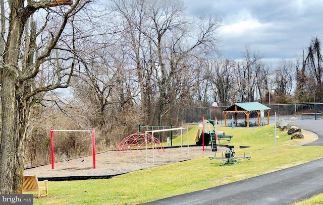 view of property's community featuring a gazebo, a lawn, and a playground