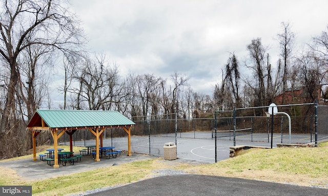 view of sport court with tennis court and a gazebo