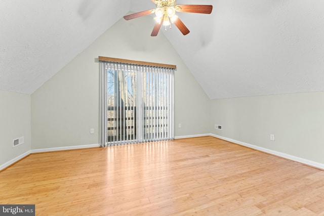 bonus room with ceiling fan, lofted ceiling, a textured ceiling, and light wood-type flooring