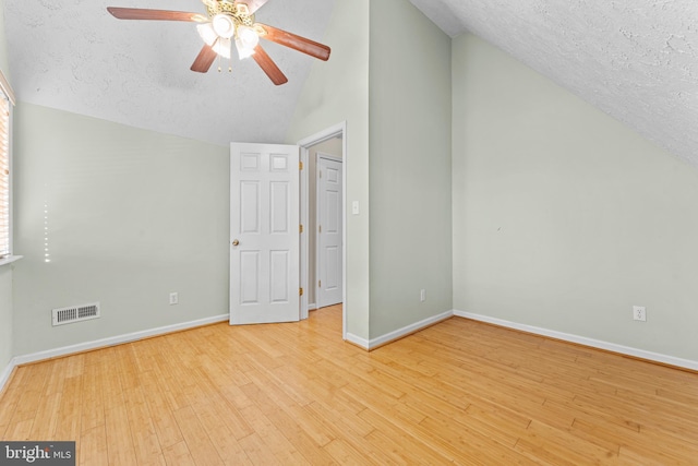 bonus room featuring ceiling fan, lofted ceiling, a textured ceiling, and light hardwood / wood-style flooring