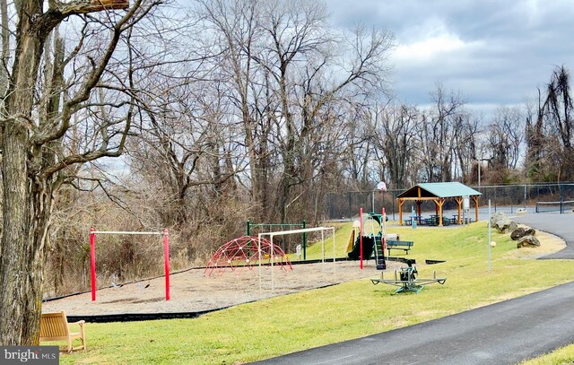 view of community with a playground, a gazebo, and a lawn