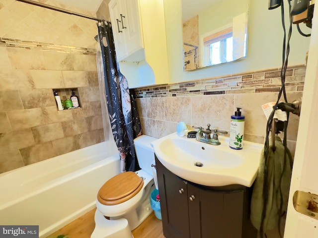 full bathroom with vanity, tile walls, shower / bathtub combination with curtain, and toilet