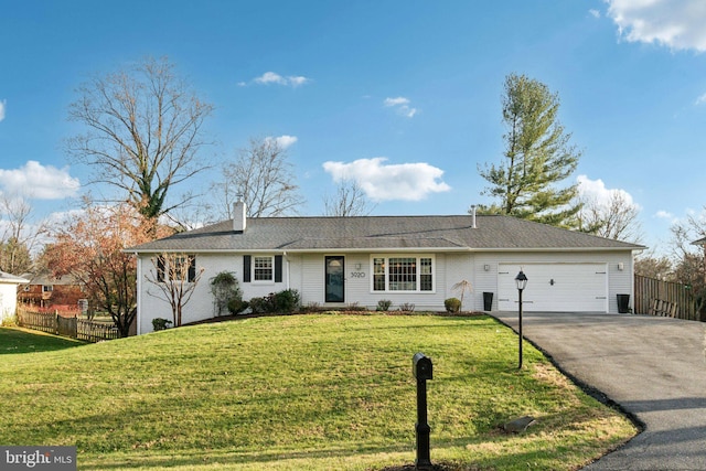 ranch-style home featuring a front lawn and a garage