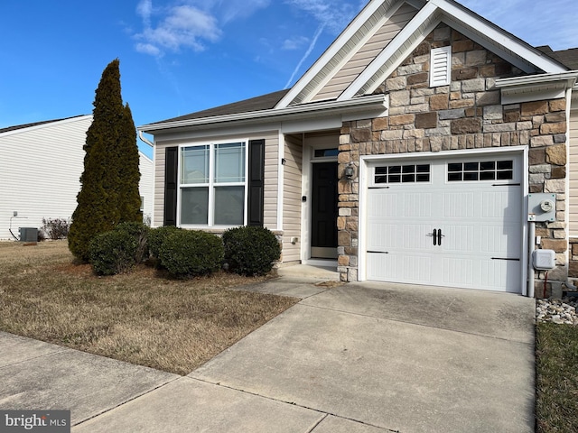 view of front of home featuring a garage and central air condition unit