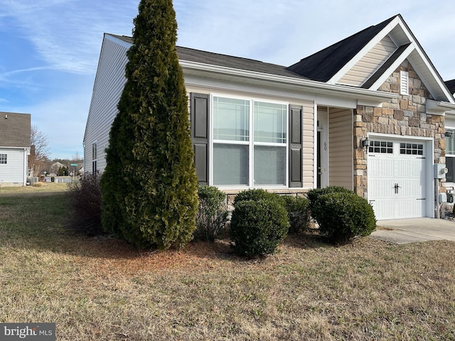 view of home's exterior featuring a yard and a garage